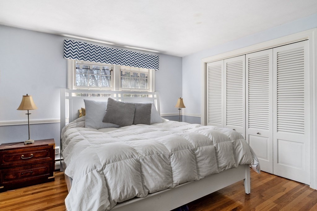 9 Bailey Lane Georgetown, MA 01833 - Photo 18 of 42 a bedroom with a bed and wooden floor