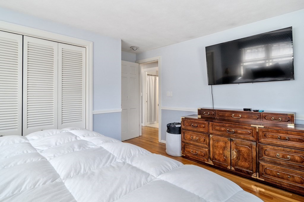 9 Bailey Lane Georgetown, MA 01833 - Photo 19 of 42 a living room with hard wood floor and flat screen tv
