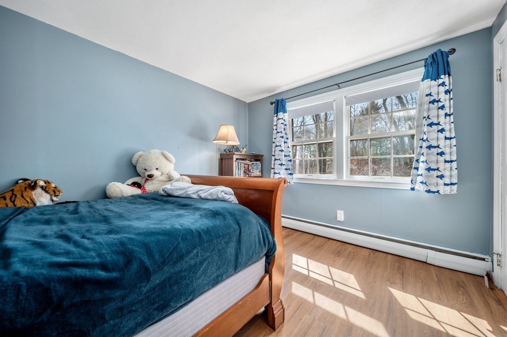 9 Bailey Lane Georgetown, MA 01833 - Photo 24 of 42 a bedroom with a bed and wooden floor
