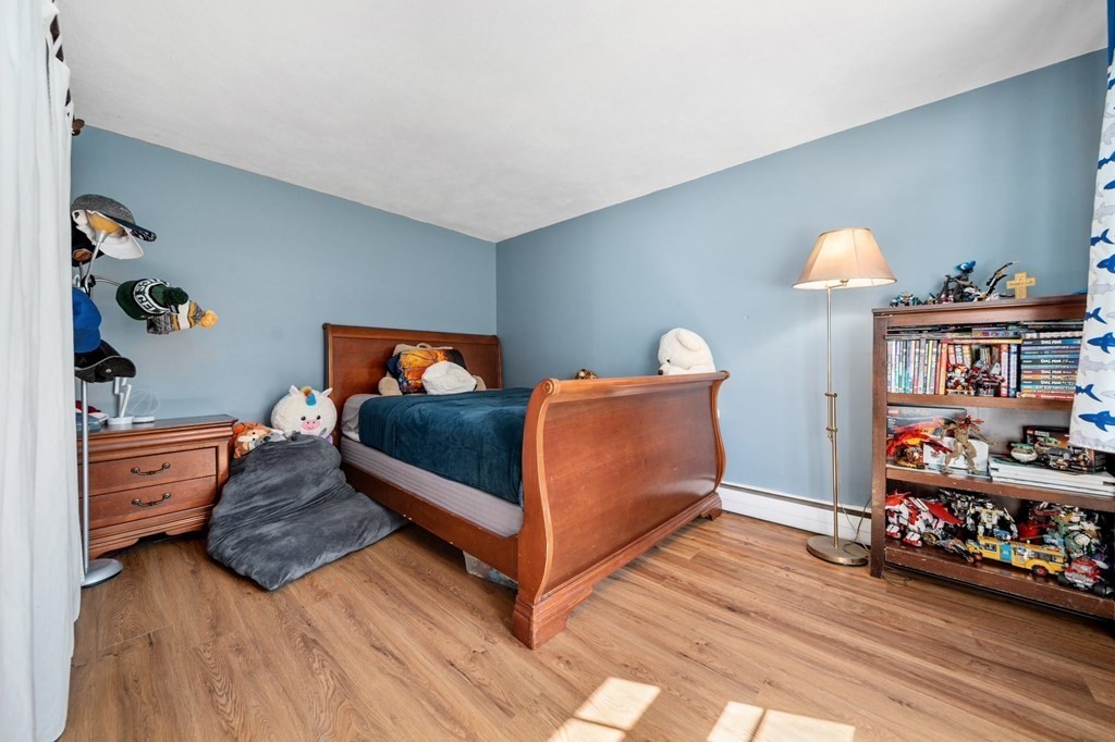 9 Bailey Lane Georgetown, MA 01833 - Photo 25 of 42 a bedroom with furniture and a book shelf