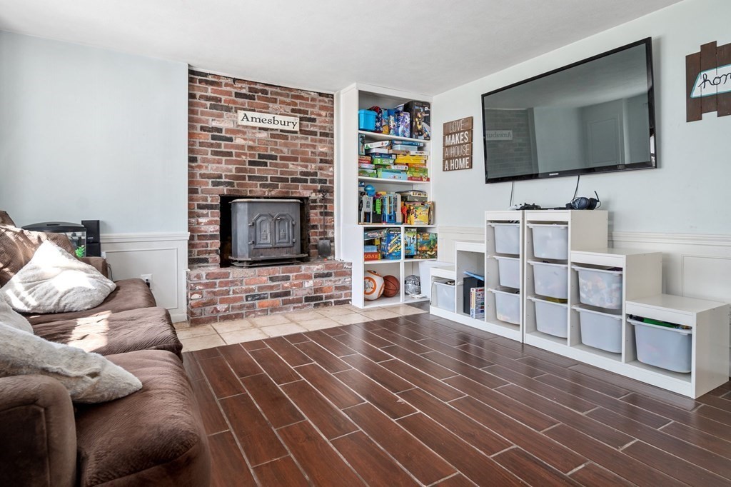 9 Bailey Lane Georgetown, MA 01833 - Photo 26 of 42 a living room with furniture and a flat screen tv