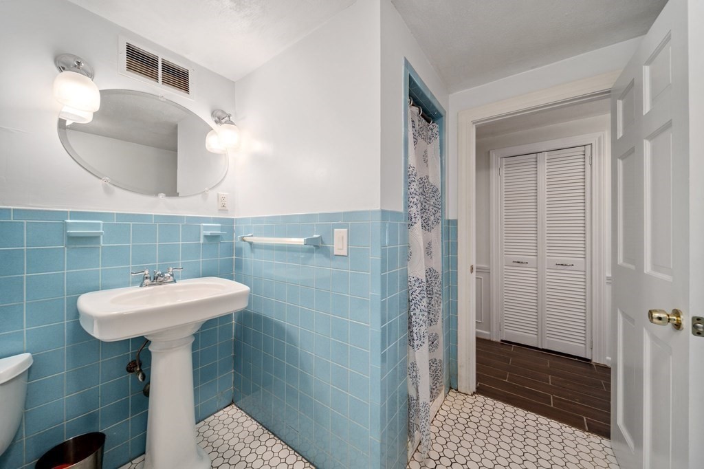 9 Bailey Lane Georgetown, MA 01833 - Photo 30 of 42 a bathroom with a sink a mirror and shower