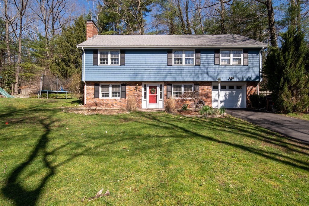 9 Bailey Lane Georgetown, MA 01833 - Photo 4 of 42 a front view of a house with a garden