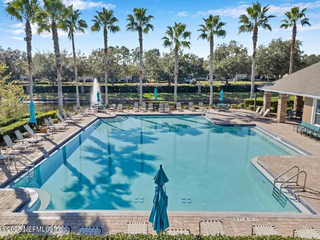 a view of a swimming pool with a table and chairs