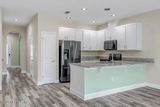 a kitchen with a refrigerator and a microwave