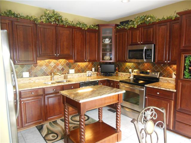 3011 Burts Crossing Springfield, TN 37172 - Photo 4 of 20 Who wouldn't want to cook in this wonderful kitchen, all appl stay, granite with island, tile back splash, under counter lighting.