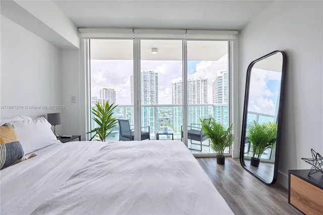 a bedroom with a large bed and a large window