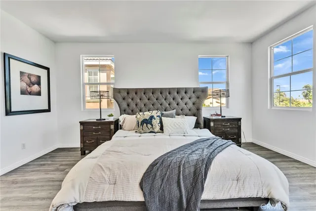 a bedroom with a bed lamp and a window