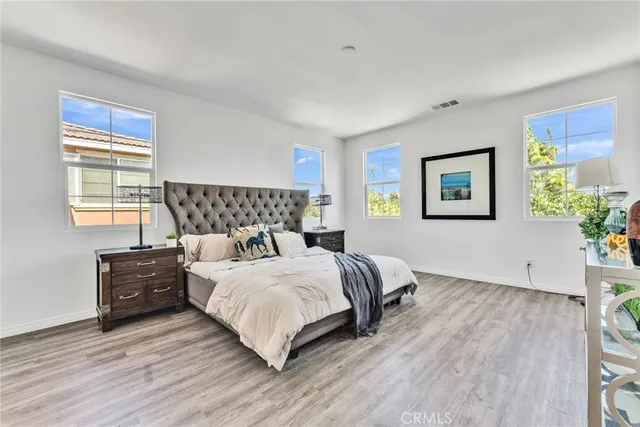 a bedroom with furniture and a flat screen tv