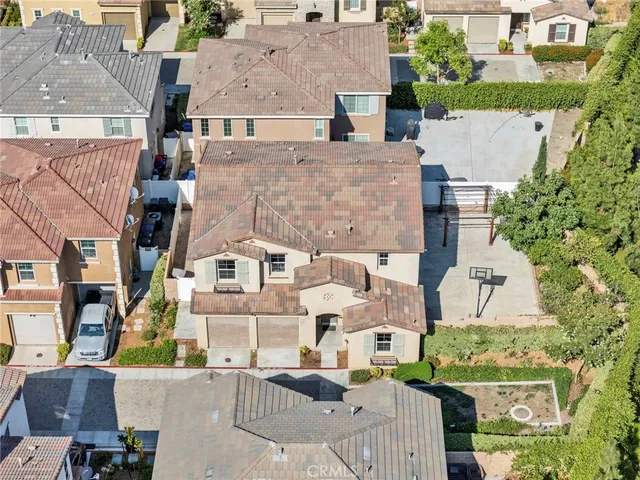 a front view of a house with a yard and potted plants