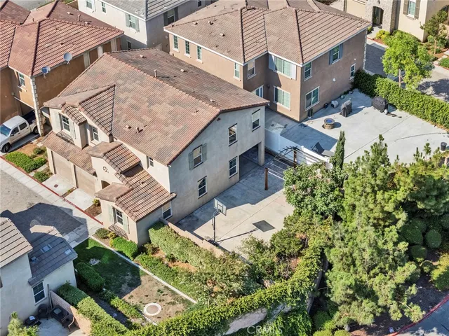 an aerial view of residential houses and car parked
