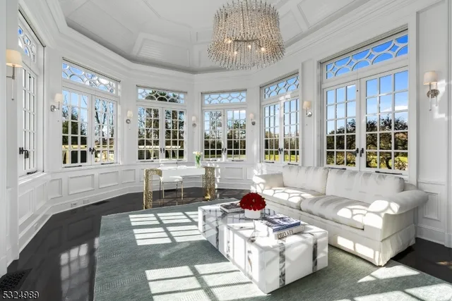 a living room with furniture and a chandelier