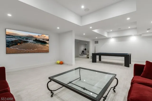 a living room with furniture and air hockey table