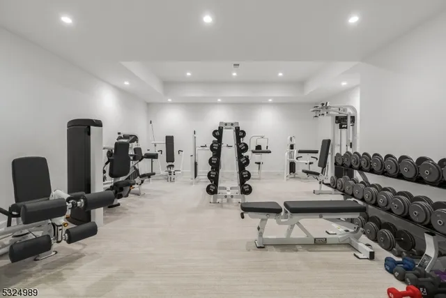 a view of a room with gym equipment and mirrors