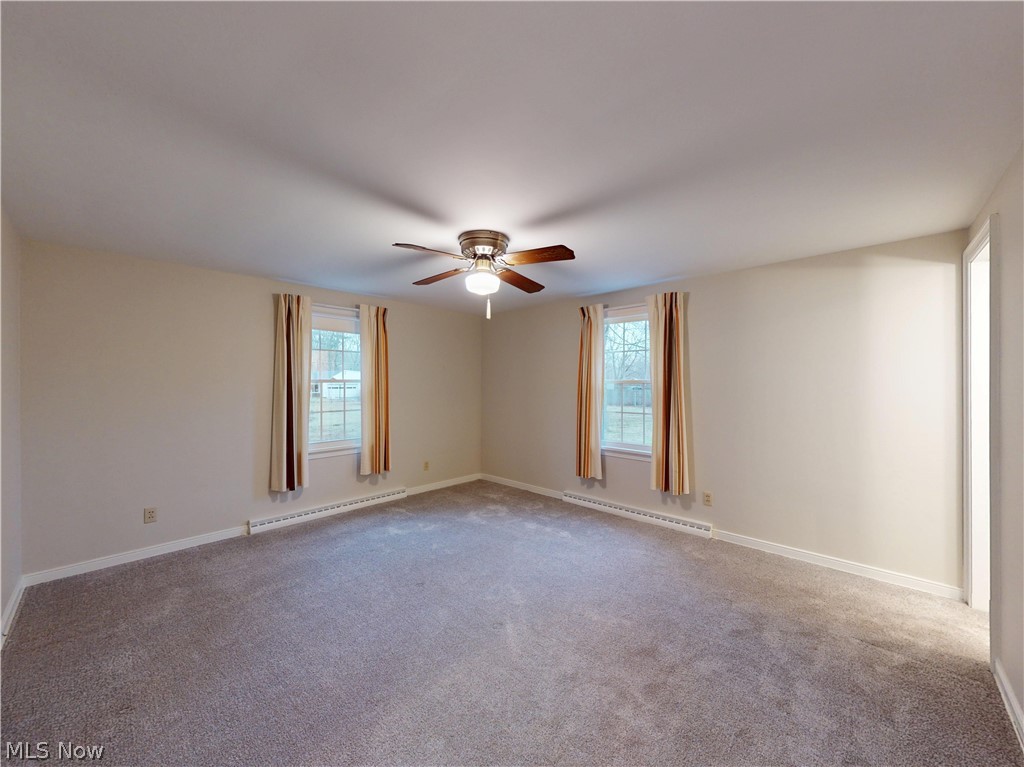 145 Overlook Road Painesville, OH 44077 - Photo 10 of 36 Unfurnished room with a baseboard heating unit, carpet floors, and ceiling fan