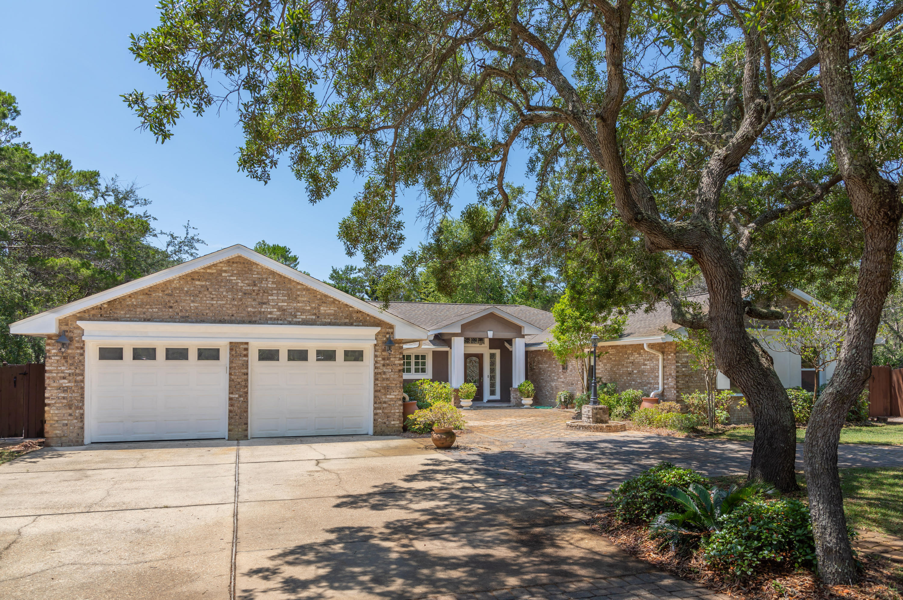 497 Walton Way Miramar Beach, FL 32550 - Photo 2 of 47 a front view of a house with garden