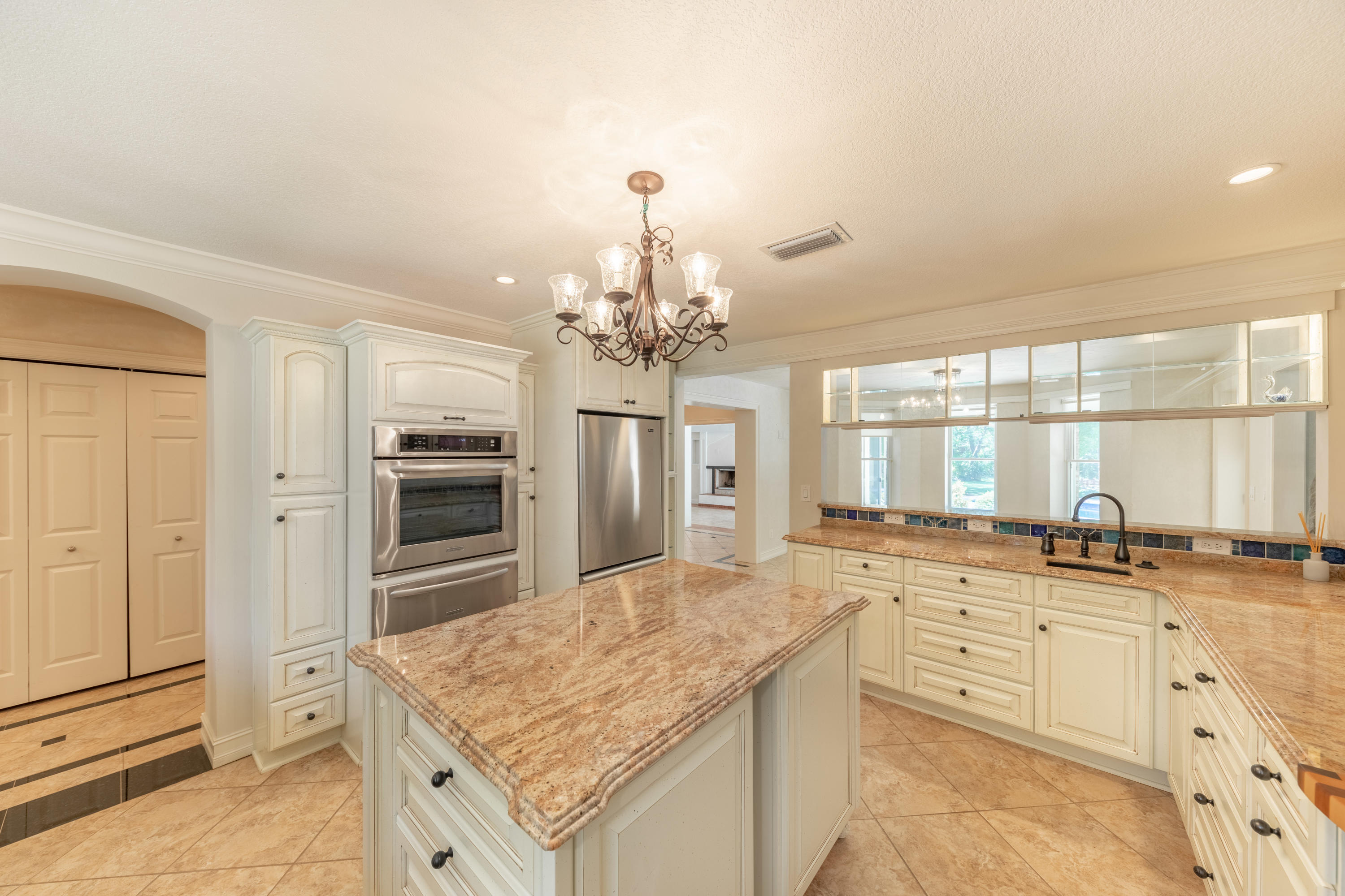 497 Walton Way Miramar Beach, FL 32550 - Photo 15 of 47 a kitchen with granite countertop a sink stove and refrigerator