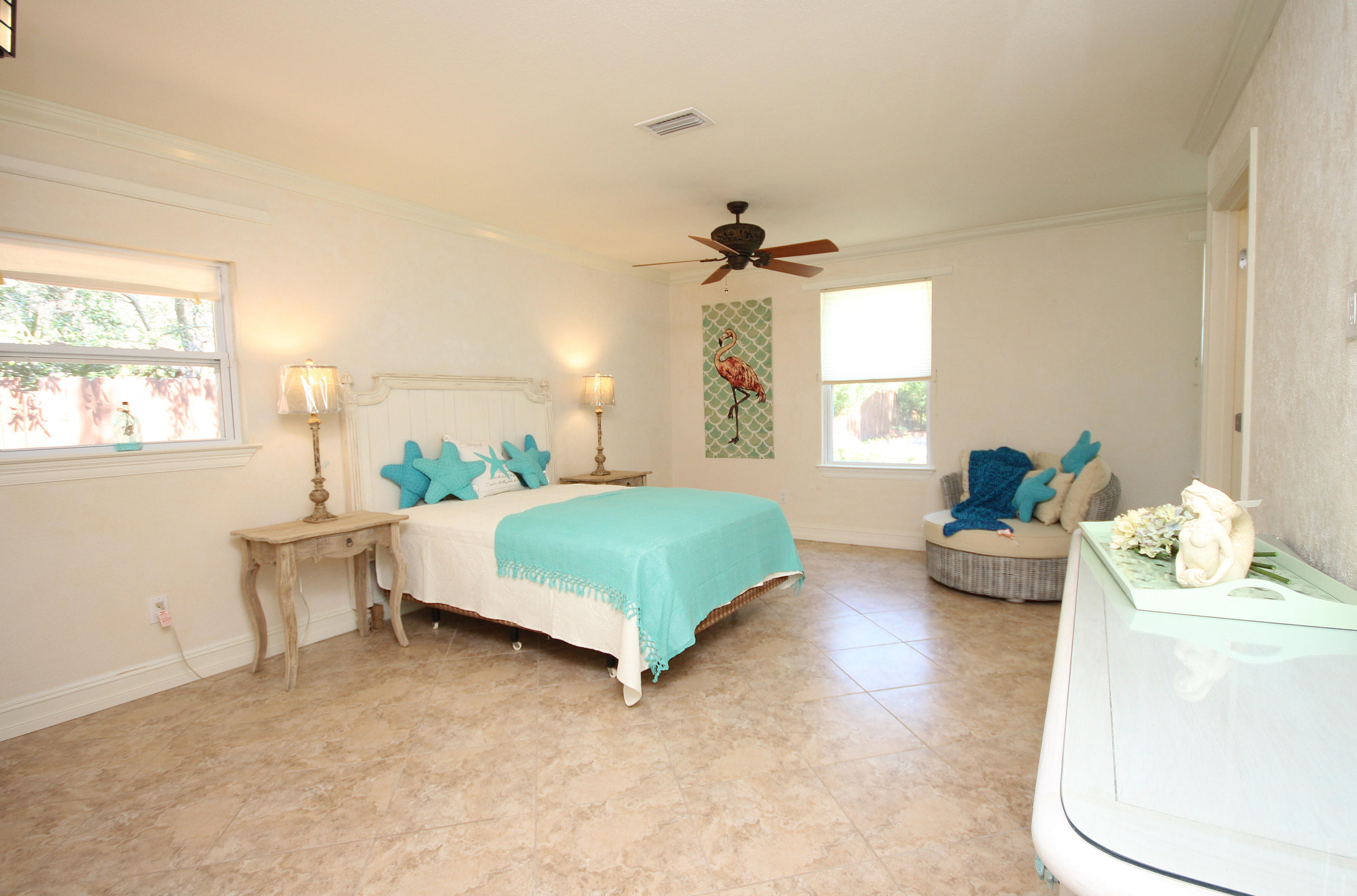 497 Walton Way Miramar Beach, FL 32550 - Photo 28 of 47 a bedroom with a bed and a chandelier