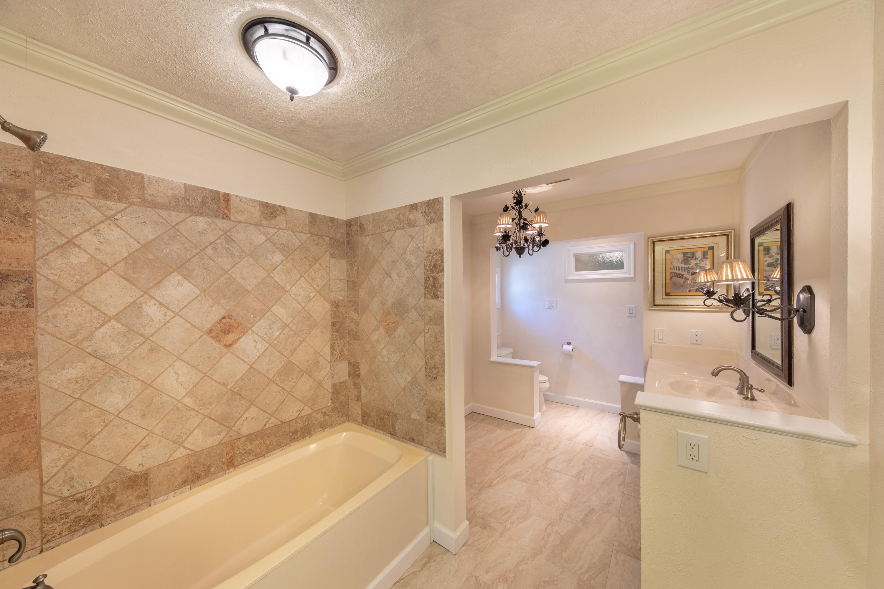 497 Walton Way Miramar Beach, FL 32550 - Photo 30 of 47 a bathroom with a tub a sink and mirror