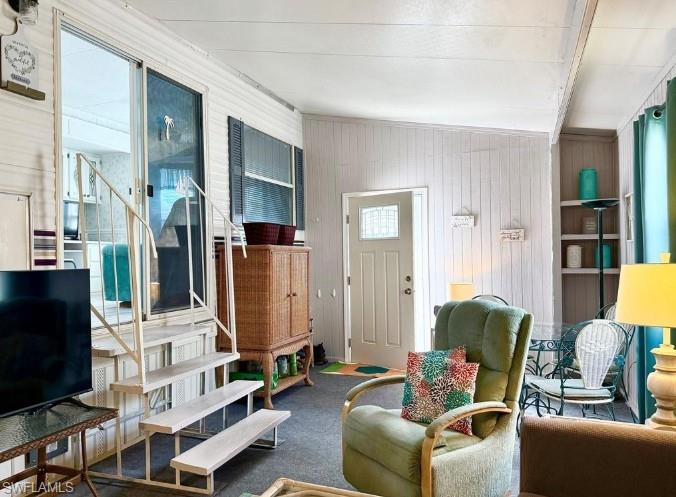 458 Vanda Sanctuary Naples, FL 34114 - Photo 11 of 50 a living room with furniture a fireplace and a flat screen tv