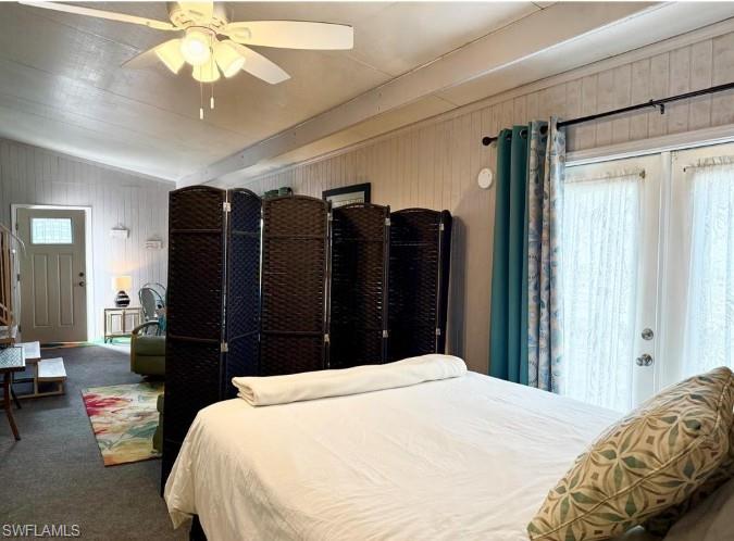 458 Vanda Sanctuary Naples, FL 34114 - Photo 13 of 50 a bedroom with a bed and a chandelier