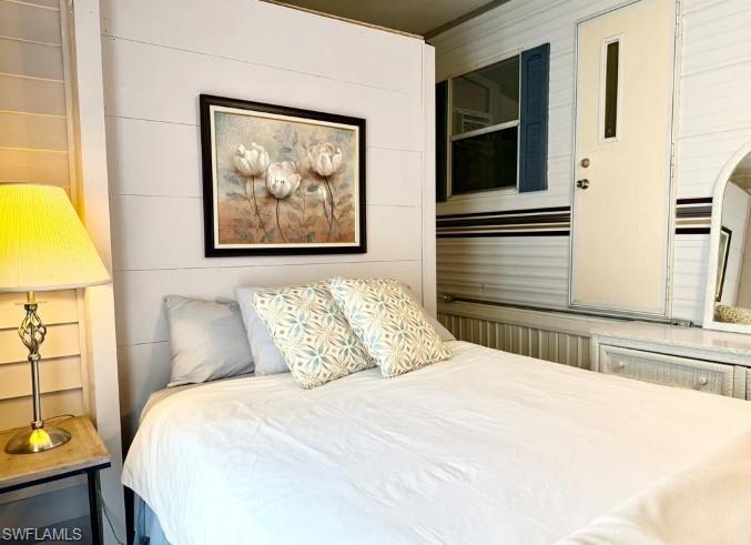 458 Vanda Sanctuary Naples, FL 34114 - Photo 15 of 50 a bedroom with a bed and a painting on the wall