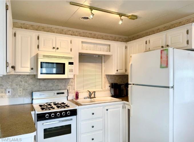 458 Vanda Sanctuary Naples, FL 34114 - Photo 17 of 50 a white refrigerator freezer and a stove sitting inside of a kitchen