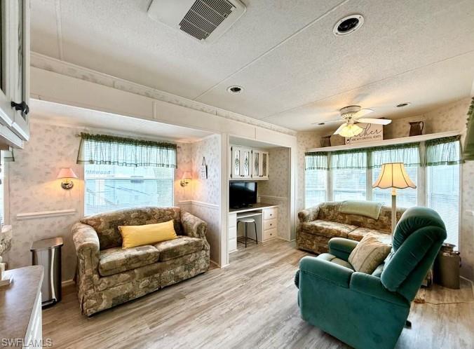 458 Vanda Sanctuary Naples, FL 34114 - Photo 20 of 50 a living room with furniture a flat screen tv and a large window