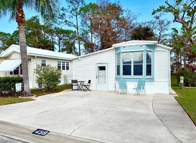 458 Vanda Sanctuary Naples, FL 34114 - Photo 2 of 50 a view of a house with a patio