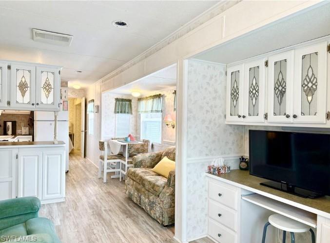 458 Vanda Sanctuary Naples, FL 34114 - Photo 21 of 50 a living room with furniture a flat screen tv and a window