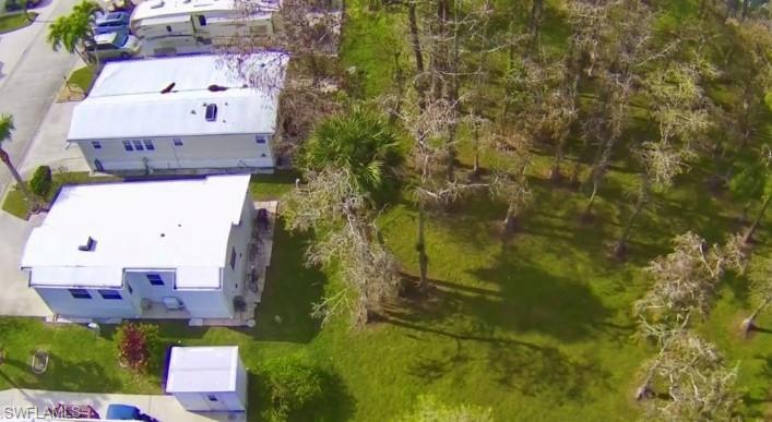 458 Vanda Sanctuary Naples, FL 34114 - Photo 29 of 50 an aerial view of residential house with outdoor space and trees all around