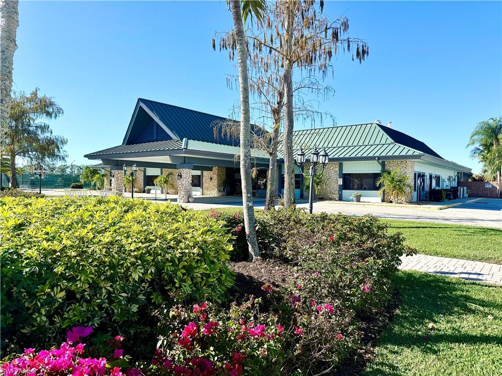 458 Vanda Sanctuary Naples, FL 34114 - Photo 33 of 50 a front view of a house with garden