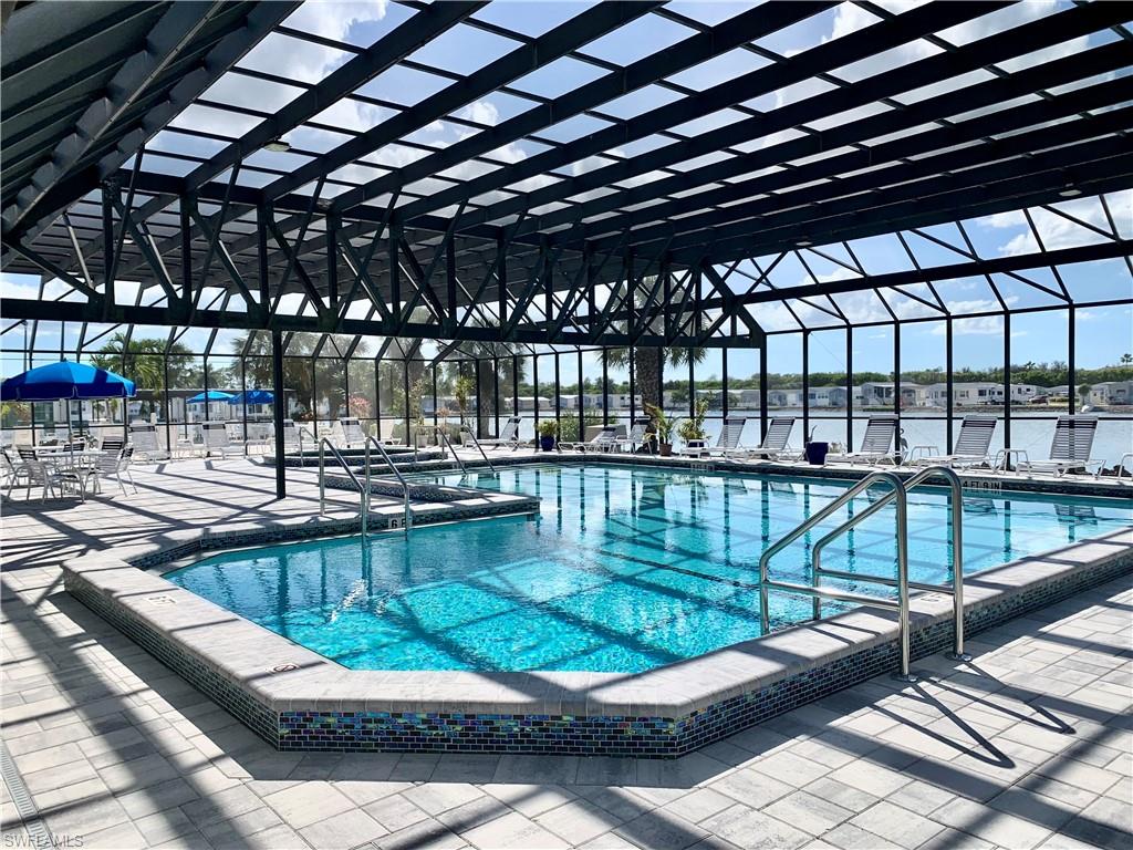 458 Vanda Sanctuary Naples, FL 34114 - Photo 35 of 50 a view of a swimming pool with a patio