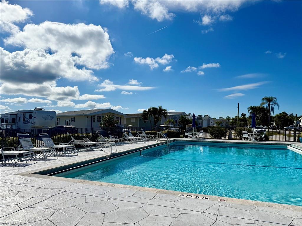 458 Vanda Sanctuary Naples, FL 34114 - Photo 40 of 50 a view of a swimming pool and lounge chairs