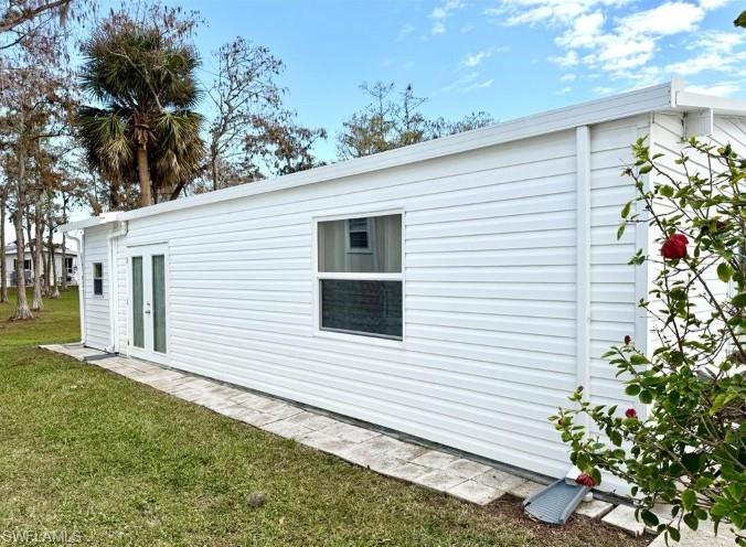 458 Vanda Sanctuary Naples, FL 34114 - Photo 7 of 50 a view of a house with a yard and potted plants