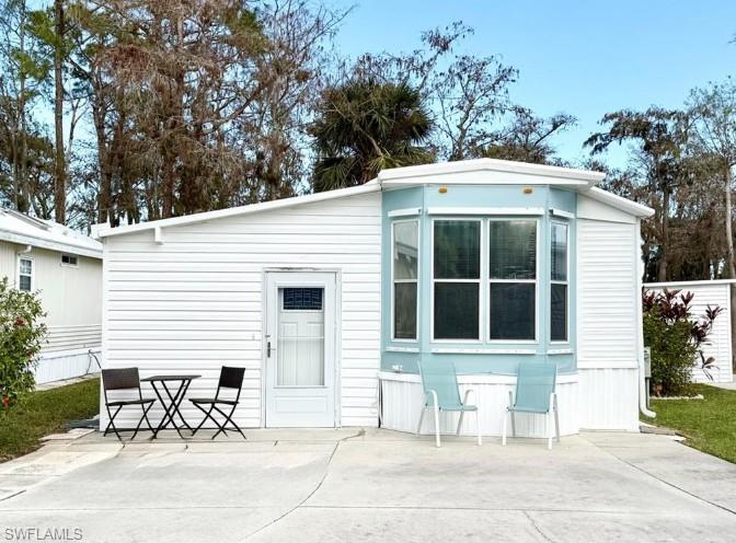 458 Vanda Sanctuary Naples, FL 34114 - Photo 8 of 50 a view of a patio with table and chairs with an outdoor space