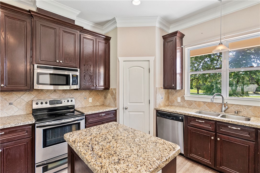 6701 Old Reliance Road Bryan, TX 77808 - Photo 13 of 44 a kitchen with a sink stove top oven and refrigerator