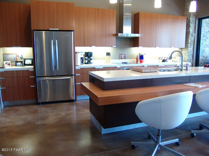 19925 North Lower Territory Road Prescott, AZ 86305 - Photo 11 of 41 a kitchen with stainless steel appliances granite countertop a refrigerator a sink dishwasher a stove a dining table and chairs with wooden floor