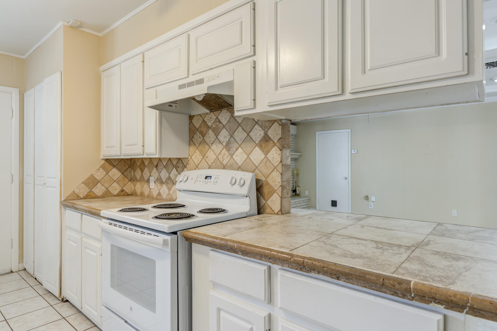 2420 39th Street Lubbock, TX 79412 - Photo 17 of 39 a kitchen with granite countertop cabinets and white appliances