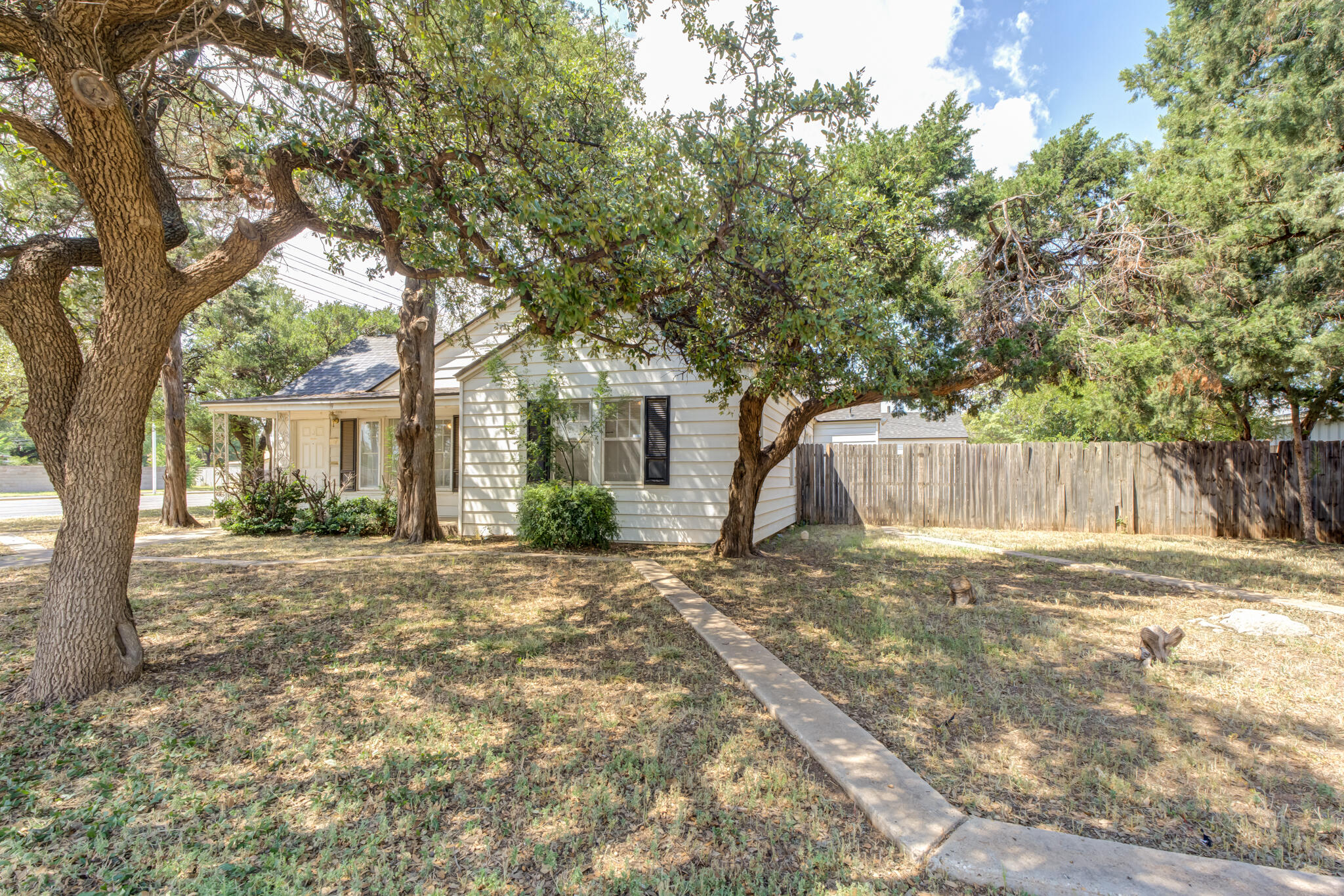 2420 39th Street Lubbock, TX 79412 - Photo 2 of 39 a front view of a house with a garden and trees