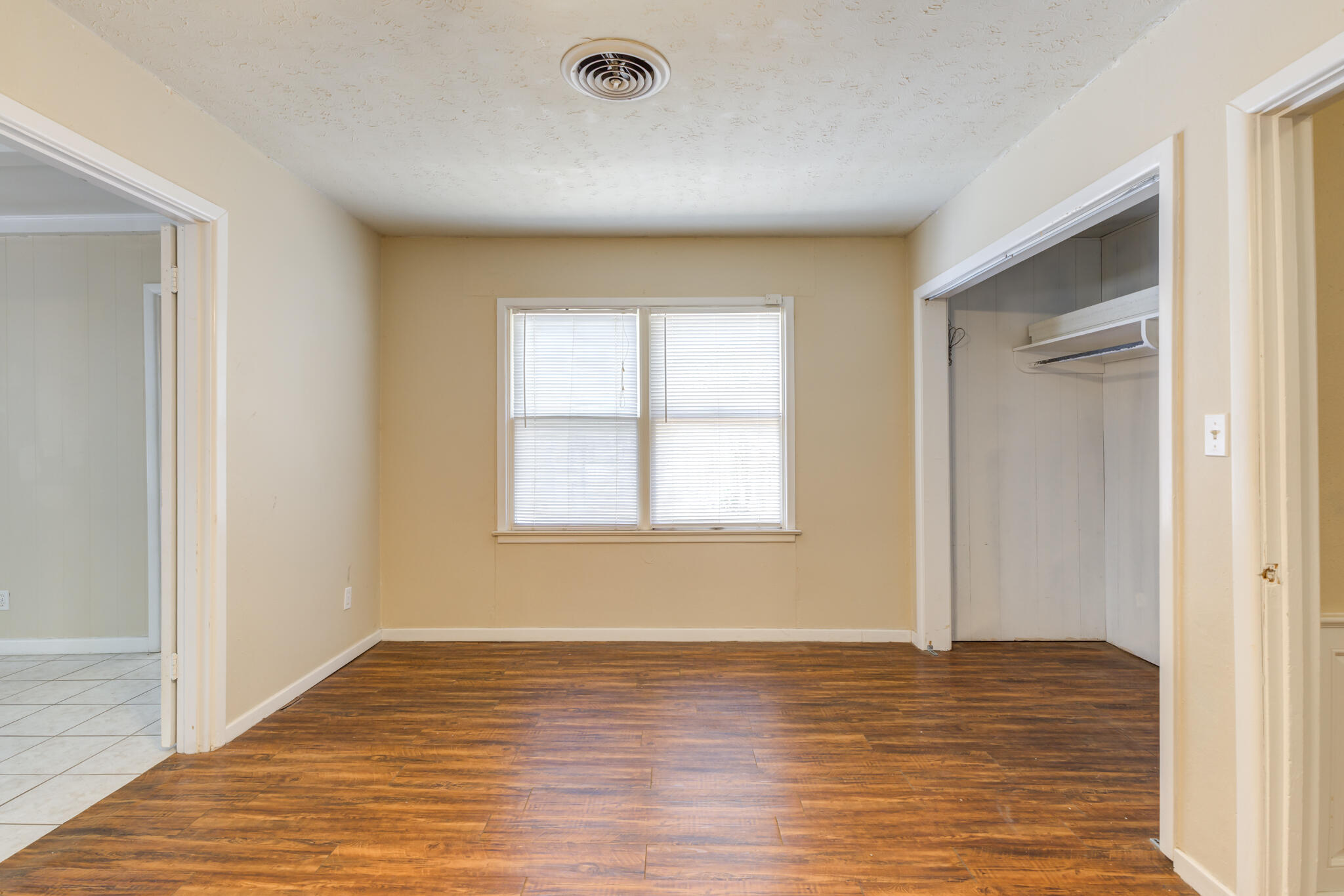 2420 39th Street Lubbock, TX 79412 - Photo 29 of 39 a view of an empty room with wooden floor and a window