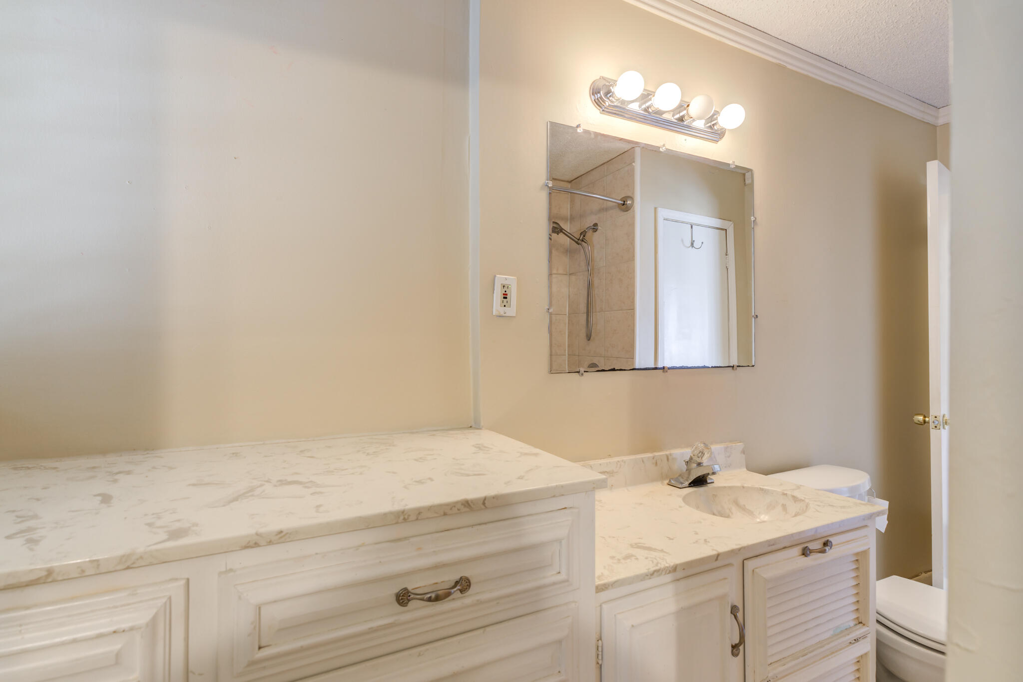 2420 39th Street Lubbock, TX 79412 - Photo 32 of 39 a bathroom with a sink vanity granite and toilet