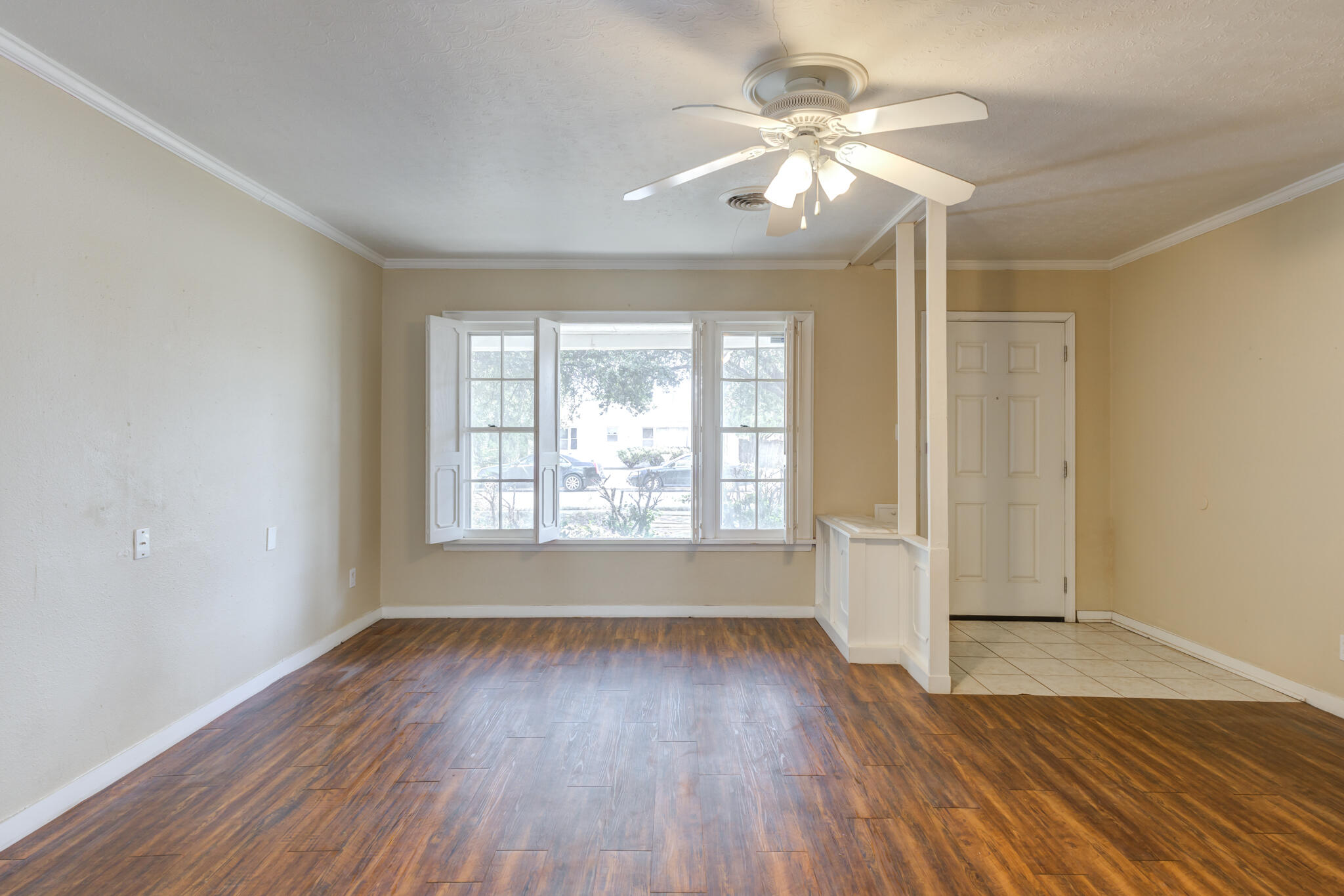 2420 39th Street Lubbock, TX 79412 - Photo 8 of 39 an empty room with wooden floor chandelier fan and windows