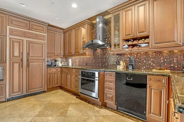 a kitchen with stainless steel appliances granite countertop a stove a sink and a microwave