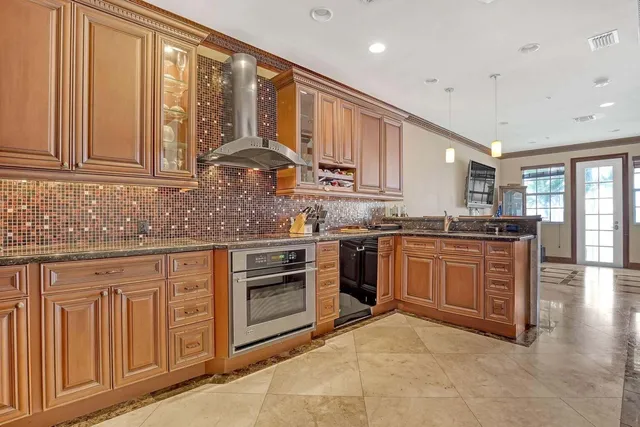 a kitchen with granite countertop a stove top oven sink and cabinets
