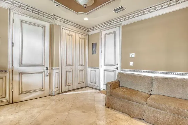 a living room with a couch and a glass door shower