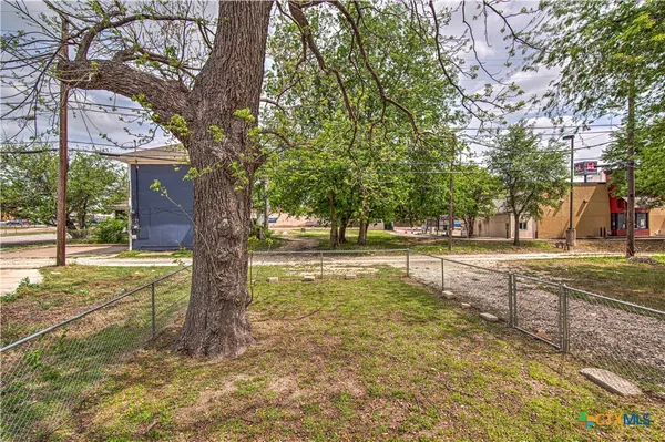 a view of a yard with trees