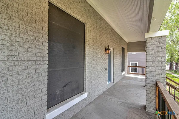 a view of a hallway with brick walls