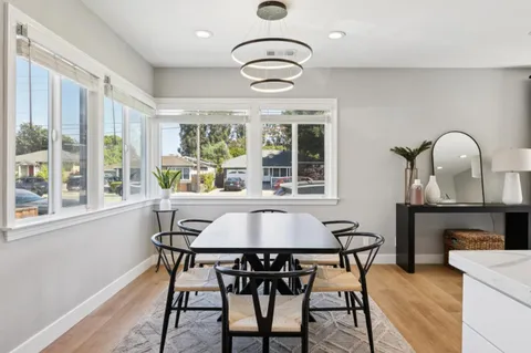 a dining room with furniture and window