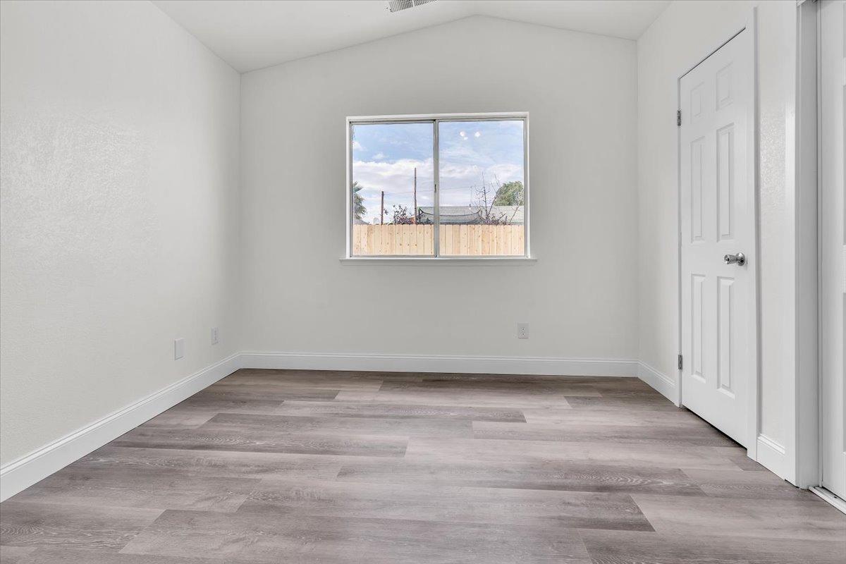 191 Orit Avenue Parlier, CA 93648 - Photo 13 of 25 wooden floor in an empty room with a window